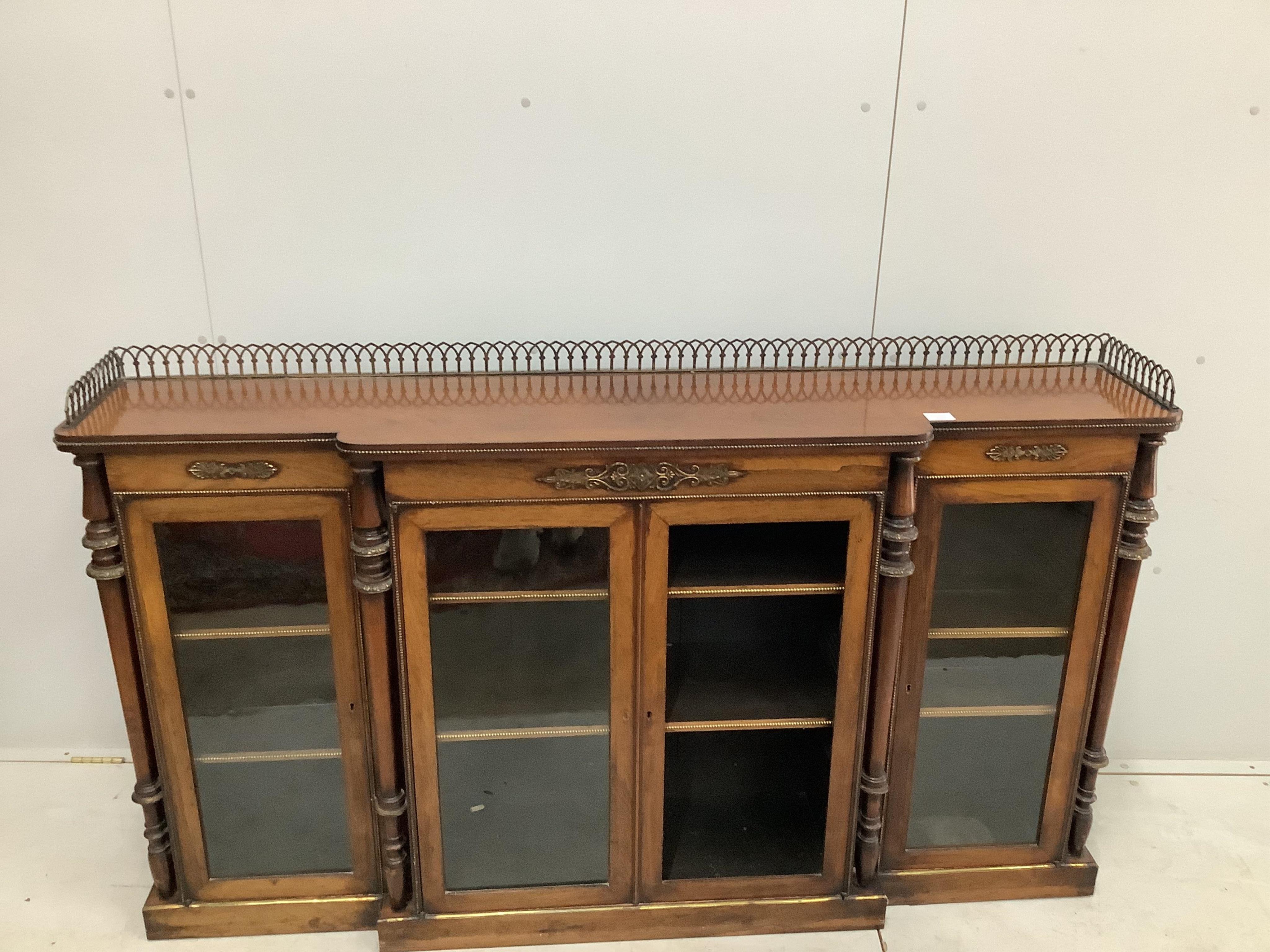 An early Victorian rosewood breakfront dwarf bookcase, width 168cm, height 97cm. Condition - one glazed panel missing, otherwise fair to good